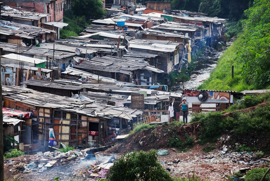 Corrego funciona como esgoto dos barracos de madeira do Jardim Peri Alto, na zona norte de Sao Paulo